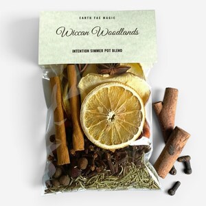 May include: A clear plastic bag containing a simmer pot blend labeled Earth Fae Magic Wiccan Woodlands Intention Simmer Pot Blend. The mixture includes dried orange slices, cinnamon sticks, star anise, cloves, and dried rosemary sprigs.