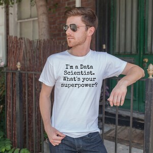 May include: A white t-shirt with black text that reads "I'm a Data Scientist. What's your superpower?"
