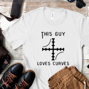 May include: White t-shirt with black text that reads "This Guy Loves Curves" and a graphic of a target with curved lines.