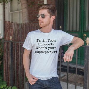 May include: A white t-shirt with black text that reads "I'm in Tech Support. What's your superpower?"