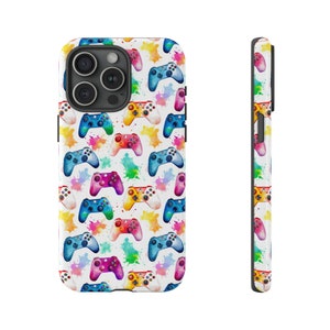 May include: A white phone case featuring a pattern of colourful watercolour game controllers. The case has a cut-out for the camera lens.