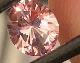 Peach pink lab sapphire , 5.40 x 4.59 x 2.93 mm, 0.55 carats, peach pink lab created sapphire, oval brilliant cut