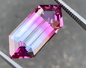 Bicolor lab sapphire , 8.95 carats, 19.96 x 8.37 x 6.53 mm, elongated hexagonal step cut, pink/purple bicolor sapphire. Precision cut