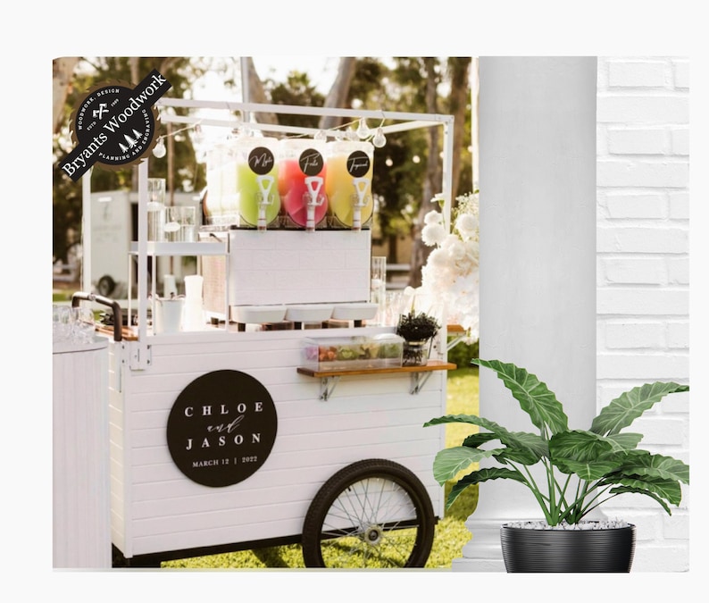 May include: White wooden cart with a black sign that says "Chloe and Jason March 12, 2022". The cart has three slushie machines with colorful slushie flavors. The cart is in front of a white brick wall and a green plant.