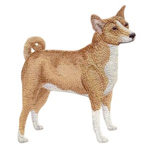 May include: Embroidered patch of a Basenji dog in a standing pose. The dog has a tan body with white markings on its chest, paws, and face. The Basenji's tail is curled, and its ears are erect.