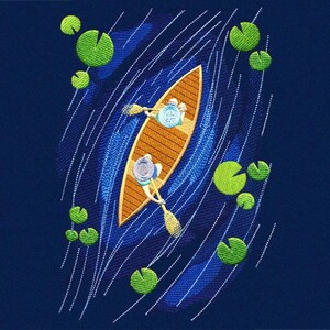 May include: An embroidered design on a dark blue background featuring a tan canoe with two figures paddling. The water is depicted with blue stitching and white dashed lines, surrounded by bright green circular lily pads scattered around.