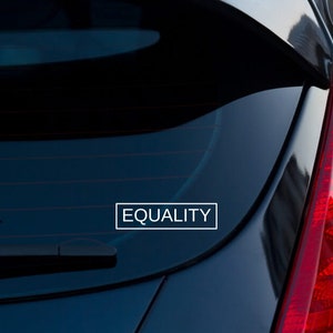 May include: A black car with a white vinyl sticker on the back window that says "EQUALITY".