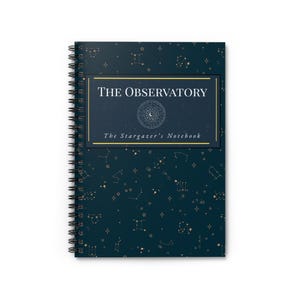 May include: A dark blue spiral-bound notebook featuring a celestial pattern of gold constellations and stars. The cover displays a rectangular frame with the text THE OBSERVATORY and The Stargazer's Notebook, along with a circular zodiac graphic.
