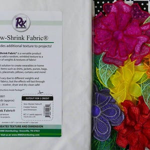 May include: White Sew-Shrink Fabric with text and a colorful floral design. The fabric is 60 x 1 yards (approx). The floral design features pink, orange, yellow, purple, and red flowers with green leaves.