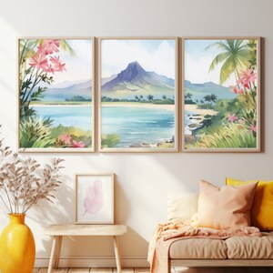 May include: A triptych of watercolour landscape prints in light wood frames depicting a tropical beach with a central mountain, palm trees, and pink flowers. The artwork is displayed above a wooden bench with a yellow vase and a small framed leaf print.