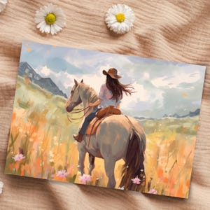 May include: An artistic print showing a person riding a horse through a field of wildflowers. The rider wears a brown hat and is seen from the back. The horse is light grey, and the background features mountains and a cloudy sky.