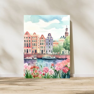 May include: Watercolor painting of a canal scene in Amsterdam, Netherlands. The painting features colorful buildings, boats, and a bridge. Pink flowers are in the foreground.