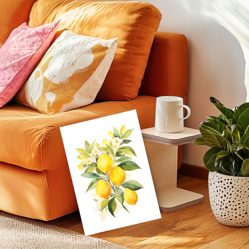 May include: A rectangular art print featuring a watercolor illustration of a lemon branch with four bright yellow lemons, green leaves, and small white blossoms against a clean white background, displayed upright on a wooden floor.