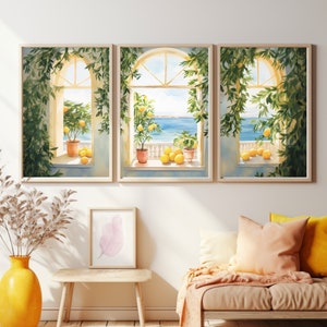 May include: Three watercolor paintings of windows with lemon trees and lemons in pots. The windows are open to a view of the ocean. The paintings are framed in light wood.