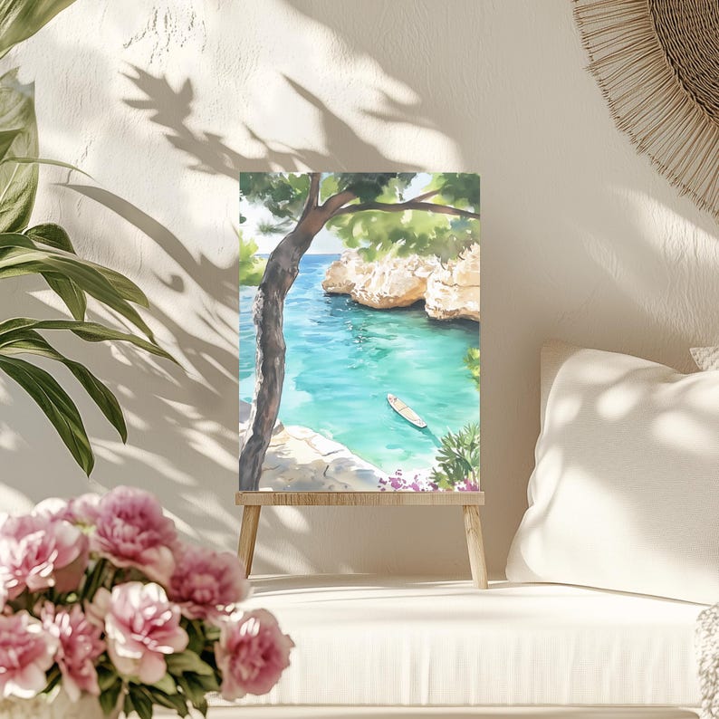 May include: Watercolor painting of a coastal scene with turquoise water, a small boat, and rocky cliffs. A tree frames the view, and the artwork is displayed on a small wooden easel. The painting evokes a sense of tranquility and natural beauty.