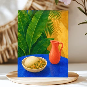 May include: A vibrant illustration featuring a beige bowl containing a mound of fufu and a portion of yellow vegetable stew, placed next to a coral-coloured ceramic pitcher on a bright blue table, set against a backdrop of lush green banana leaves.