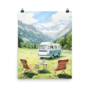 May include: A blue and white camper van parked in a grassy field with two red and white folding chairs and a small table with a teapot and cups. The van is parked in front of a mountain range with snow-capped peaks.