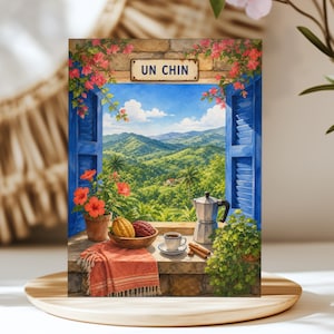 May include: A rectangular print featuring a window with blue shutters, pink bougainvillea, and a view of green mountains. On the stone sill sits a bowl of cacao pods, a cup of coffee, a moka pot, cinnamon sticks, and a fringed orange cloth.