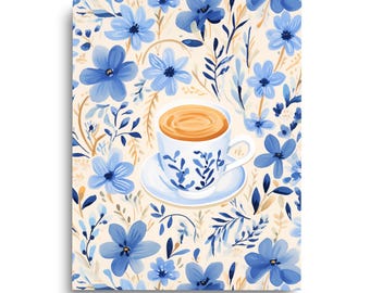 May include: A white ceramic teacup and saucer filled with a light brown beverage, decorated with blue floral patterns, centred on a background featuring a repeating pattern of blue flowers and foliage on a cream-coloured surface.