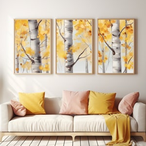May include: A triptych of framed wall art prints featuring birch trees with white bark and vibrant yellow autumn leaves. The three vertical rectangular frames are displayed side-by-side, showcasing a forest scene with light grey and yellow tones.
