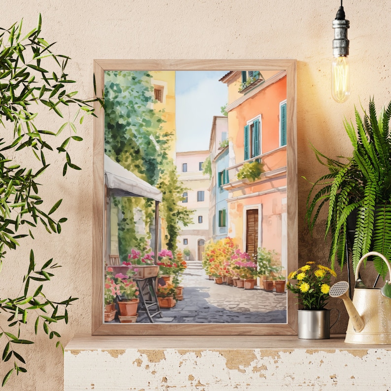 May include: Watercolor painting of a narrow street in a European city. The street is lined with colorful buildings and potted plants. A white awning covers a cafe on the left side of the street.