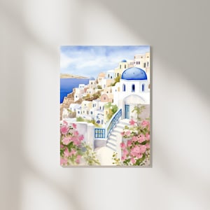 Puede incluir: Una pintura en acuarela de un pueblo costero con edificios blancos de techos abovedados azules, escaleras de piedra y barandillas azules. La escena incluye flores de buganvilla de color rosa vibrante en primer plano y un mar azul.
