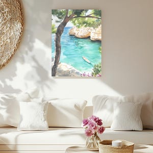 May include: Watercolor painting of a coastal scene with turquoise water, cliffs, and a small boat. A tree frames the view, with green foliage and a glimpse of the blue sky. The artwork is displayed on a white wall.