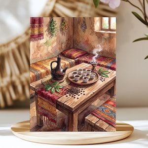 May include: A watercolor illustration of a wooden table set with a dark brown coffee pot, a round tray holding six small cups, and scattered coffee beans. The scene includes patterned textiles, hanging dried herbs, and a steaming incense burner.