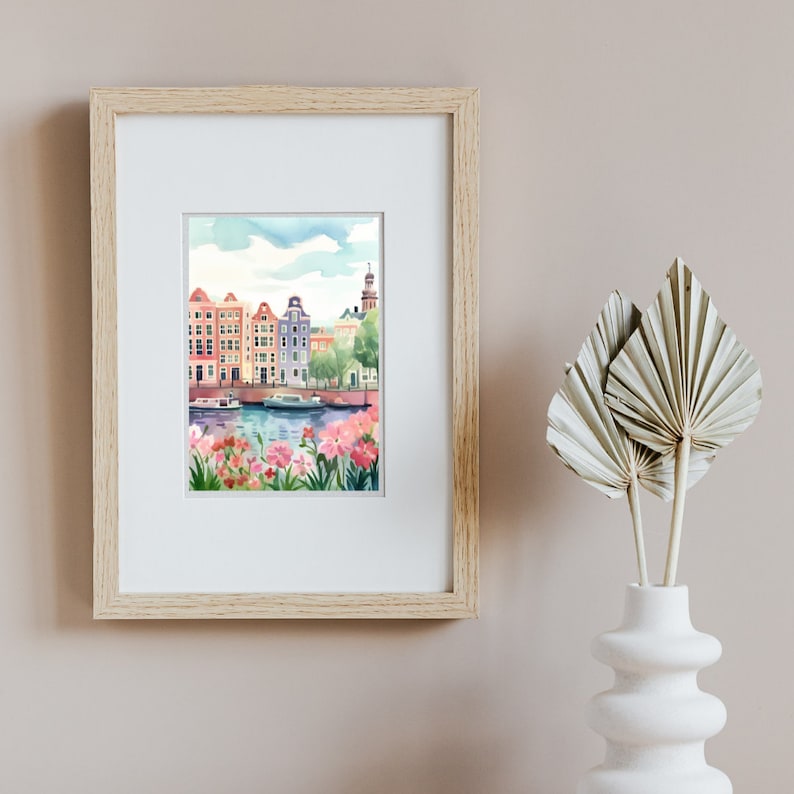May include: A watercolor painting of a canal scene in a European city. The painting features colorful buildings, a canal with boats, and pink flowers in the foreground.