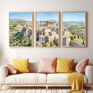 May include: A triptych wall art set featuring a watercolor painting of the Parthenon and ancient Greek ruins on a hillside. The three framed prints display a continuous landscape with stone structures, green trees, and a clear blue sky.