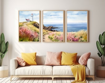 May include: Three framed watercolor paintings depicting a coastal scene with a lighthouse, a rocky shore, and a view of the ocean. The paintings are hung on a white wall above a white couch with yellow and pink throw pillows.