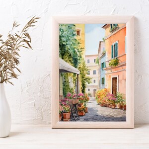 May include: Watercolor painting of a narrow street in a European city. The street is lined with colorful buildings and potted plants. A cafe awning is visible in the foreground.