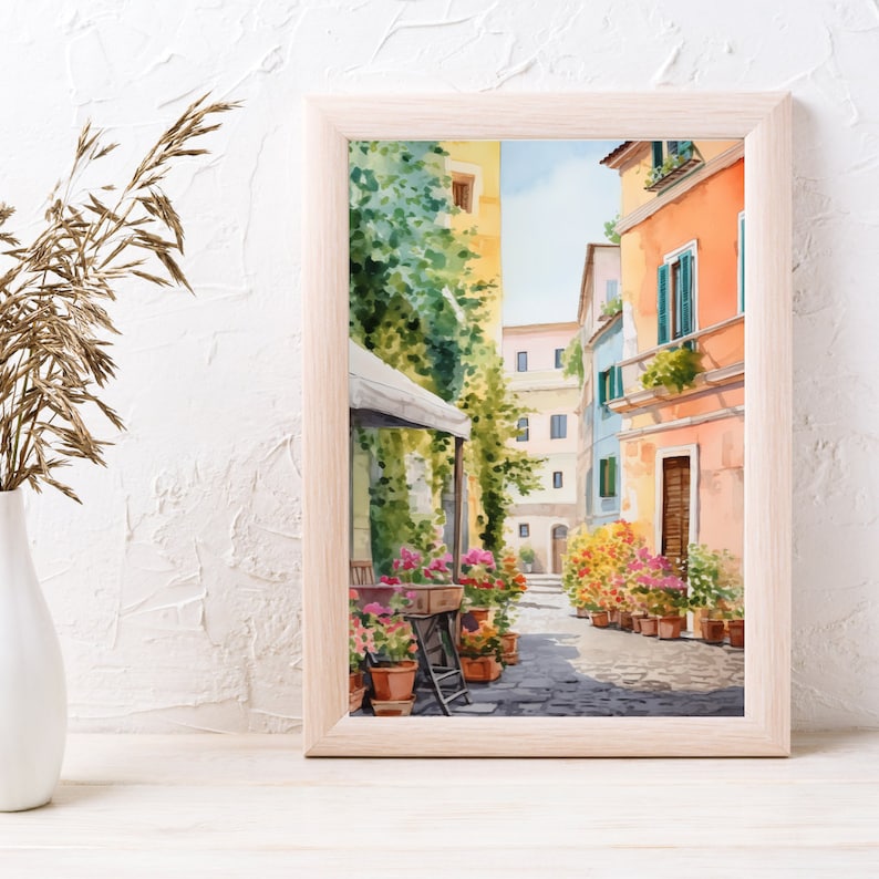 May include: Watercolor painting of a narrow street in a European city. The street is lined with colorful buildings and potted plants. A cafe awning is visible in the foreground.