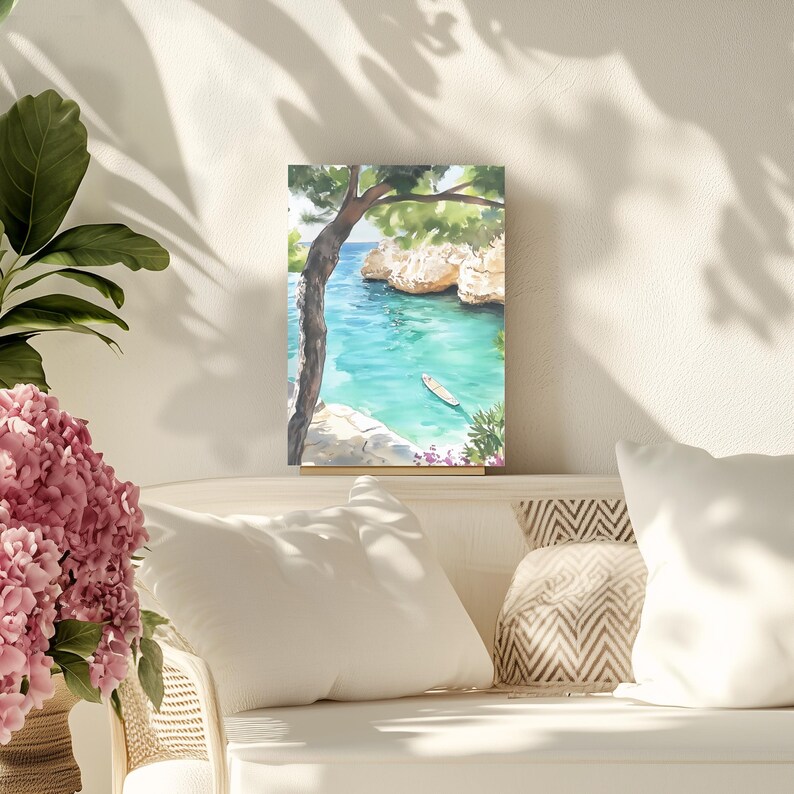 May include: Watercolor painting of a coastal scene with turquoise water, a small boat, and rocky cliffs. A tree frames the view, with green foliage and a glimpse of blue sky. The artwork is displayed on a white surface.