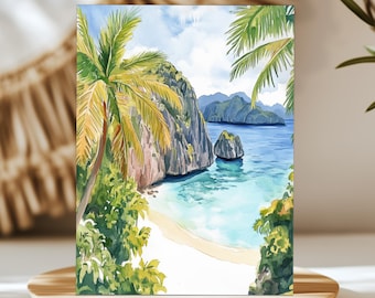 May include: A rectangular art print featuring a watercolour painting of a tropical beach scene. The image displays a sandy shore, turquoise water, a large rocky cliff, and a small island in the distance, framed by green palm tree fronds.