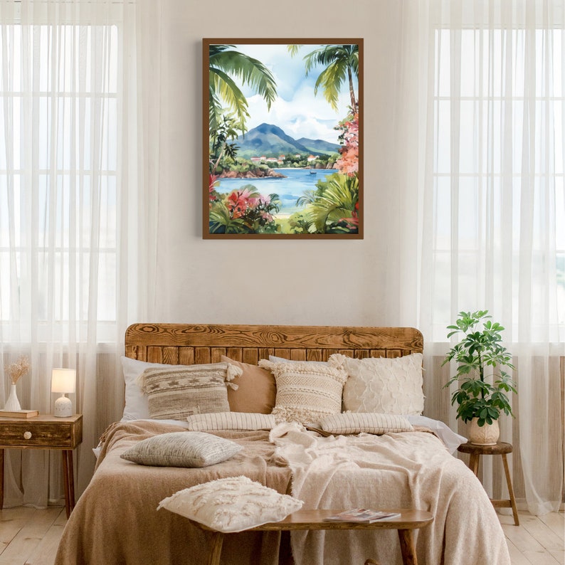 May include: A watercolor painting of a tropical island scene with lush green palm trees, a blue body of water, and a mountain in the background. The painting is framed in a brown wood frame and is hanging on a white wall.