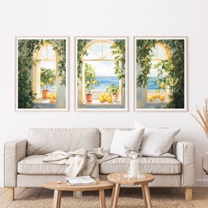 May include: Three framed watercolor paintings of windows with views of the ocean. Each window is adorned with a potted lemon tree and lemons on the windowsill. The windows are framed in wood with a white background.