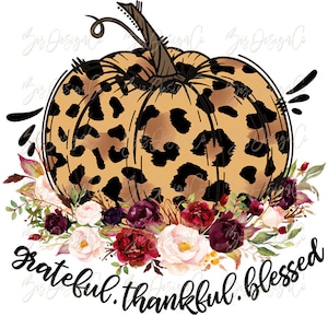 May include: A graphic illustration of a pumpkin with a tan and black leopard print pattern, featuring a brown stem and a cluster of burgundy, red, and white flowers at the base. The text "grateful. thankful. blessed" is written in black script.