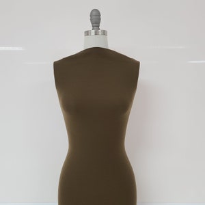 May include: A brown sleeveless dress form made of fabric. The dress form is on a white background.