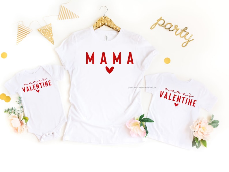 May include: White t-shirts with red text and hearts. The larger shirt says "MAMA" and the smaller shirt says "mama's VALENTINE".