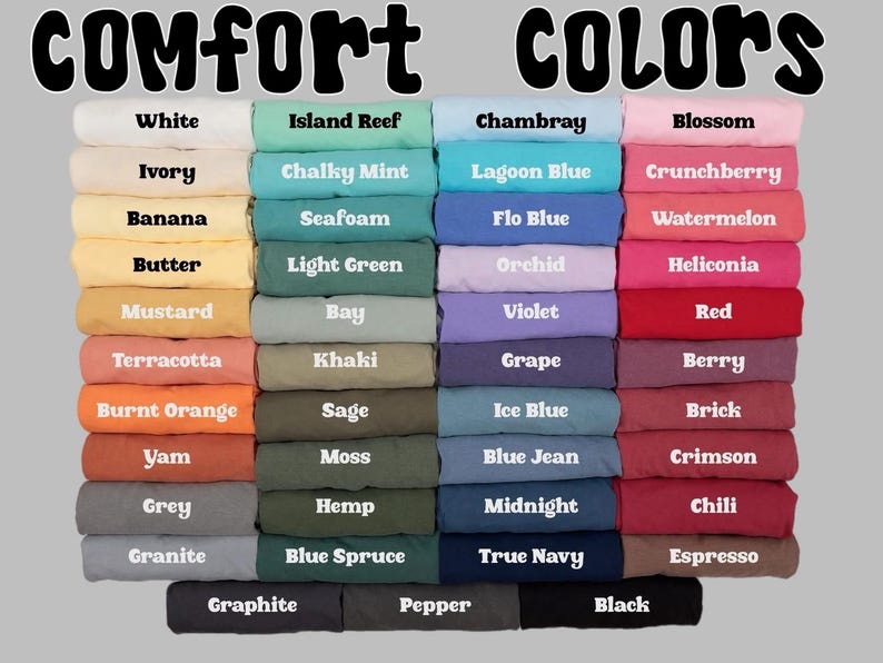May include: Image displaying a color chart with the words "Comfort COLORS" at the top. The chart features a variety of folded fabric samples in shades like white, blue, pink, and green, each labeled with a color name.