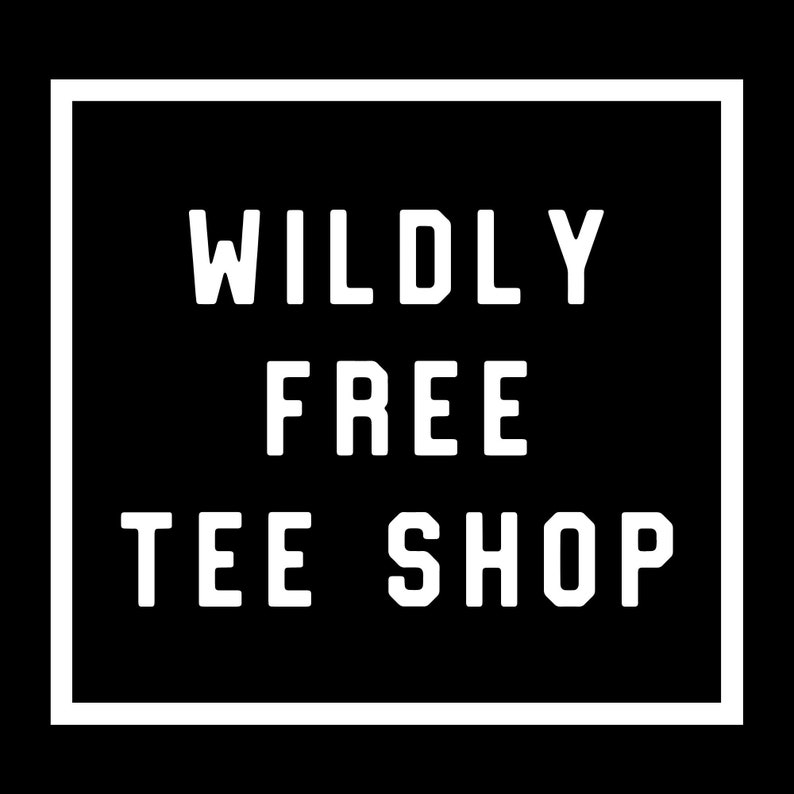 May include: A white square with a black background and the text "WILDLY FREE TEE SHOP" in white.
