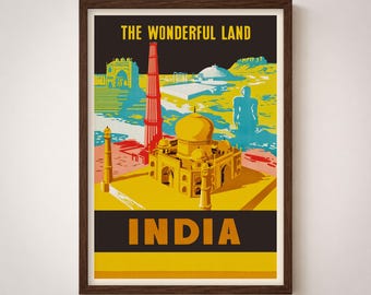 Puede incluir: Un póster de viaje enmarcado titulado THE WONDERFUL LAND INDIA que presenta una ilustración estilizada del Taj Mahal en amarillo, un minarete rojo alto y siluetas arquitectónicas azules sobre un fondo oscuro con texto amarillo.