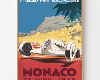 May include: Vintage poster print for the 7th Grand Prix Automobile in Monaco, 1935. The artwork features a white race car speeding across a red and orange background, with the text "MONACO" and the date. The sky is blue.