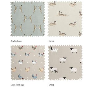 May include: Four fabric swatches with different animal prints. The top left swatch features a light blue background with a white and brown hare pattern. The top right swatch features a beige background with a white and brown hare pattern. The bottom left swatch features a beige background with a white and brown chicken pattern. The bottom right swatch features a beige background with a white and black sheep pattern. The swatches are labeled "Boxing hares", "Hares", "Lay a little egg", and "Sheep".
