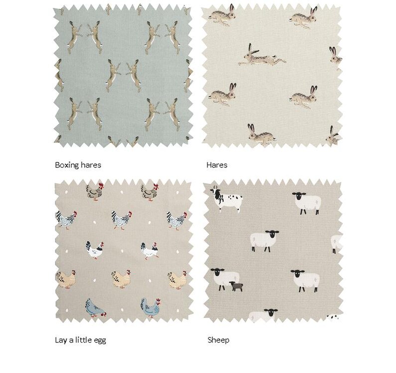 May include: Four fabric swatches with different animal prints. The top left swatch features a light blue background with a white and brown hare pattern. The top right swatch features a beige background with a white and brown hare pattern. The bottom left swatch features a beige background with a white and brown chicken pattern. The bottom right swatch features a beige background with a white and black sheep pattern. The swatches are labeled "Boxing hares", "Hares", "Lay a little egg", and "Sheep".