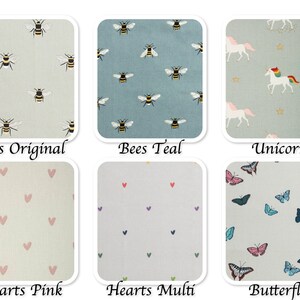 May include: Six fabric swatches with different patterns: bees on a light green background, bees on a teal background, unicorns on a light blue background with gold stars, pink hearts on a light beige background, multi-colored hearts on a light beige background, and butterflies on a light blue background.