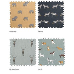 May include: Four fabric swatches with different animal prints. The first swatch is a light brown fabric with a repeating pattern of gray elephants. The second swatch is a dark blue fabric with a repeating pattern of black and white zebras. The third swatch is a light blue fabric with a repeating pattern of brown stag. The fourth swatch is a light blue fabric with a repeating pattern of brown and white dogs.