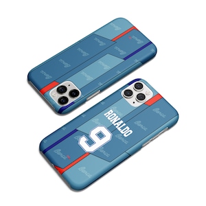May include: Two blue phone cases with a soccer jersey design. One case features the name "RONALDO" and the number "9" in white. The cases have a light blue and dark blue color scheme with red accents and the word "Barca" printed on them.