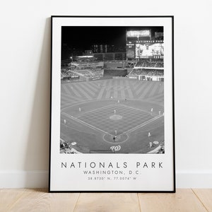 May include: Black and white aerial photograph of Nationals Park, a baseball stadium in Washington, D.C. The image shows the field, the stands, and the scoreboard. The text "Nationals Park, Washington, D.C. 38.8730° N, 77.0074° W" is printed below the image.